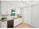 Bright kitchen with granite countertops, stainless steel appliances, and white cabinets at 5259 Sugar Ridge Dr, Sugar Hill, GA 30518