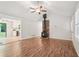Bright living room with hardwood floors, a wood burning stove and open access to kitchen at 5259 Sugar Ridge Dr, Sugar Hill, GA 30518
