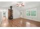 Bright living room with hardwood floors, a vaulted ceiling, wood burning stove and windows with shutters at 5259 Sugar Ridge Dr, Sugar Hill, GA 30518