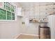 Well-organized pantry features wire shelving, mini fridge, and a window for natural light at 5259 Sugar Ridge Dr, Sugar Hill, GA 30518