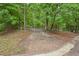 Gated property line nestled among lush green trees at 5259 Sugar Ridge Dr, Sugar Hill, GA 30518