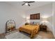 Bedroom featuring queen size bed, ceiling fan, wood floor, and large decorative mirror at 800 Peachtree Ne St # 8429, Atlanta, GA 30308