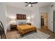 Bedroom featuring queen size bed, ceiling fan, wood floor, and doorways to bathroom and closet at 800 Peachtree Ne St # 8429, Atlanta, GA 30308