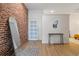 Modern entryway with brick accent wall, stylish mirror, and contemporary decor at 800 Peachtree Ne St # 8429, Atlanta, GA 30308