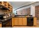 Modern kitchen featuring stainless steel appliances, light wood cabinets, and beautiful hardwood flooring at 800 Peachtree Ne St # 8429, Atlanta, GA 30308
