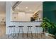 Kitchen bar with dark countertop and bar stools with light wood cabinets in background at 800 Peachtree Ne St # 8429, Atlanta, GA 30308