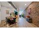Open-concept living and dining area with exposed brick walls and modern furnishings at 800 Peachtree Ne St # 8429, Atlanta, GA 30308