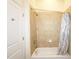 This bathroom features a tiled shower with a curtain at 870 Mayson Turner Nw Rd # 1447, Atlanta, GA 30314