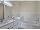 Bright bathroom features a dual sink vanity and soaking tub with tile surround at 870 Mayson Turner Nw Rd # 1447, Atlanta, GA 30314