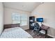 Cozy bedroom with a bed, desk, and chair, ideal for work or relaxation at 1867 Castleberry Ln, Buford, GA 30518