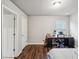 Bright bedroom features dark hard wood floors, neutral walls, and access to an ensuite bathroom at 1867 Castleberry Ln, Buford, GA 30518