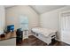 Bedroom features hard wood flooring, neutral paint, a large window, and ensuite bath access at 1867 Castleberry Ln, Buford, GA 30518