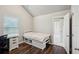 Bedroom features hard wood flooring, neutral paint, a large window, and ensuite bath access at 1867 Castleberry Ln, Buford, GA 30518