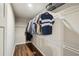 Walk-in closet with wood floor, shelving and racks for optimal storage at 1867 Castleberry Ln, Buford, GA 30518