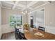 Formal dining room featuring hardwood floors, coffered ceilings, and a modern chandelier at 1867 Castleberry Ln, Buford, GA 30518