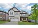 Charming two-story home with a two-car garage, manicured lawn and brick and siding accents at 1867 Castleberry Ln, Buford, GA 30518