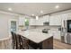 Modern kitchen with stainless steel appliances, white cabinetry, granite counters, and large island with seating at 1867 Castleberry Ln, Buford, GA 30518