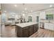 Open floor plan view of the kitchen with stainless steel appliances, granite countertops, and large island at 1867 Castleberry Ln, Buford, GA 30518