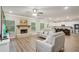 Spacious living room with a fireplace, wood-look floors, and open layout to the modern kitchen at 1867 Castleberry Ln, Buford, GA 30518