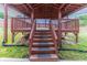 Inviting backyard featuring stairs leading up to a covered deck, perfect for outdoor living at 204 Saintvry Path, Atlanta, GA 30349