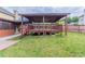 Large backyard featuring a spacious covered deck with a wooden railing at 204 Saintvry Path, Atlanta, GA 30349