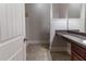 Bathroom featuring tiled floors, dark wood vanity, and granite countertop at 204 Saintvry Path, Atlanta, GA 30349