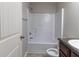 Well-lit bathroom with a shower and tub combination and a vanity with a dark countertop at 204 Saintvry Path, Atlanta, GA 30349