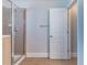 Tiled bathroom with glass-enclosed shower and a door to the bedroom at 204 Saintvry Path, Atlanta, GA 30349
