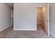 Comfortable bedroom with carpet, an open closet, and neutral paint at 204 Saintvry Path, Atlanta, GA 30349