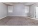 Spacious bedroom with plush carpeting and a view of two large windows at 204 Saintvry Path, Atlanta, GA 30349