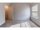 Neutral bedroom with plush carpet, window with blinds, and walk-in closet at 204 Saintvry Path, Atlanta, GA 30349