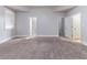 Carpeted bedroom with natural light and multiple door entries at 204 Saintvry Path, Atlanta, GA 30349