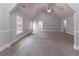 Spacious bonus room featuring neutral paint, carpet, and ceiling fan at 204 Saintvry Path, Atlanta, GA 30349