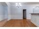 Elegant dining space with hardwood floors, chandelier, and view of kitchen at 204 Saintvry Path, Atlanta, GA 30349