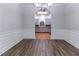 Dining room features hardwood floors, crown molding, and an arched entry leading to the kitchen at 204 Saintvry Path, Atlanta, GA 30349