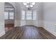 Elegant dining room with hardwood floors, tray ceiling, and large windows at 204 Saintvry Path, Atlanta, GA 30349