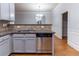 Updated kitchen showcasing stainless steel dishwasher and granite countertops at 204 Saintvry Path, Atlanta, GA 30349