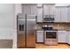 Modern kitchen featuring stainless steel appliances, gray cabinets, and granite countertops at 204 Saintvry Path, Atlanta, GA 30349