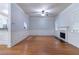 Open-concept living area with hardwood floors, fireplace, and seamless flow to kitchen at 204 Saintvry Path, Atlanta, GA 30349