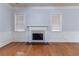 Bright living room featuring a classic fireplace, hardwood floors, and large windows at 204 Saintvry Path, Atlanta, GA 30349
