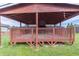 Backyard pergola features brown painted wood and wide plank decking at 204 Saintvry Path, Atlanta, GA 30349