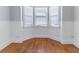 Cozy sitting area with a bay window, wood floors, and white wainscoting at 204 Saintvry Path, Atlanta, GA 30349