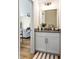 Stylish half bath with granite countertop, white cabinets, and modern lighting at 213 Starr Cir, Stockbridge, GA 30281