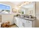 Bright bathroom featuring double sinks, granite countertops, and a large window at 213 Starr Cir, Stockbridge, GA 30281