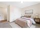Inviting bedroom with plush carpeting, stylish bedding, and warm neutral tones at 213 Starr Cir, Stockbridge, GA 30281
