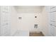 A small laundry area with connections for a washer and dryer and white wire shelving at 213 Starr Cir, Stockbridge, GA 30281