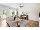 Bright living room with large windows, neutral decor, and stylish furniture at 213 Starr Cir, Stockbridge, GA 30281