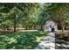 Spacious backyard featuring mature trees, a shed for storage, and a well-maintained lawn at 3265 Bethesda Park Ct, Lawrenceville, GA 30044