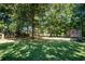 Expansive backyard with mature trees, providing shade and privacy with storage shed on the side at 3265 Bethesda Park Ct, Lawrenceville, GA 30044