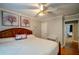 Elegant bedroom with a wooden bed frame, hardwood floors, soft lighting, and decorative floral artwork at 3265 Bethesda Park Ct, Lawrenceville, GA 30044